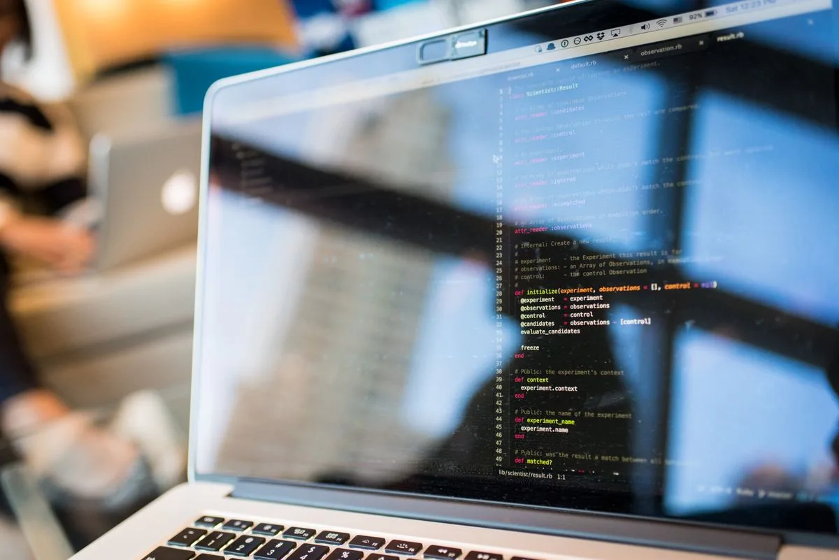 Software developer working with code on a laptop